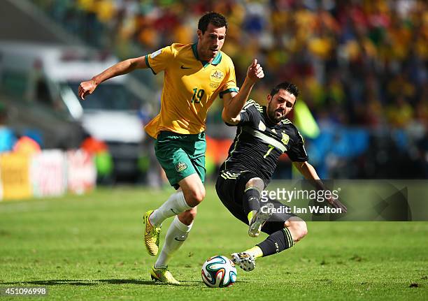 Ryan McGowan of Australia is challenged by David Villa of Spain during the 2014 FIFA World Cup Brazil Group B match between Australia and Spain at...