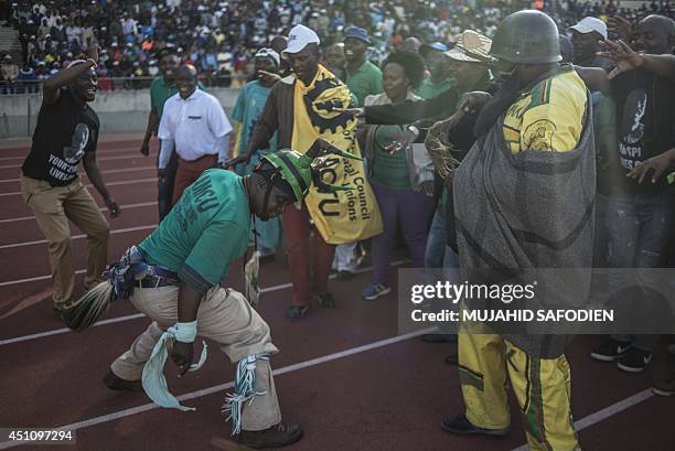 South African platinum miners dance before Association of Mineworkers and Construction Union leader announces the end of South Africa's five-month...