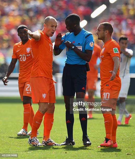 Arjen Robben and Wesley Sneijder of the Netherlands protest to referee Bakary Gassama during the 2014 FIFA World Cup Brazil Group B match between the...