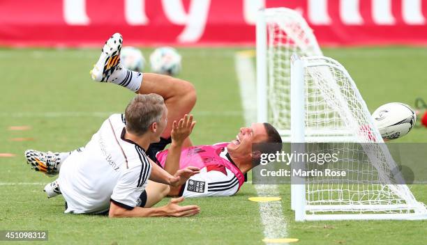 Lukas Podolski of Germany battles with team mate Bastian Schweinsteiger for the ball during the German national team training at Campo Bahia on June...