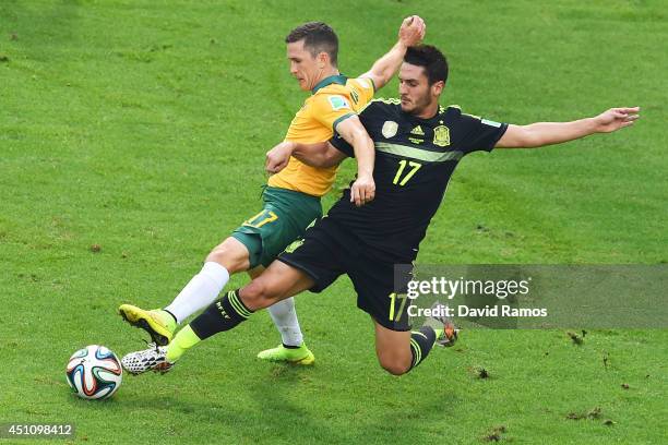 Koke of Spain challenges Matt McKay of Australia during the 2014 FIFA World Cup Brazil Group B match between Australia and Spain at Arena da Baixada...