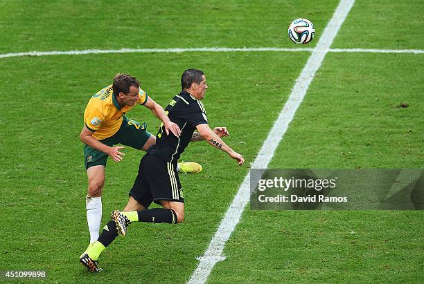 Alex Wilkinson of Australia challenges Fernando Torres of Spain during the 2014 FIFA World Cup Brazil Group B match between Australia and Spain at...