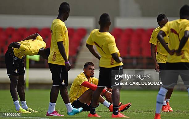 Ghana's forward Kevin-Prince Boateng speaks with teammates during training at the Rei Pele stadium, Ghana's base training camp in Maceio, on June 23,...