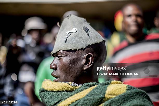 South African miner sings while taking part in a rally where the Association of Mineworkers and Construction Union's leader announced the end of...