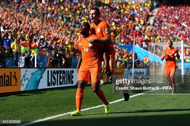 Leroy Fer of the Netherlands celebrates scoring his team's first goal with his teammate Stefan de Vrij during the 2014 FIFA World Cup Brazil Group B...