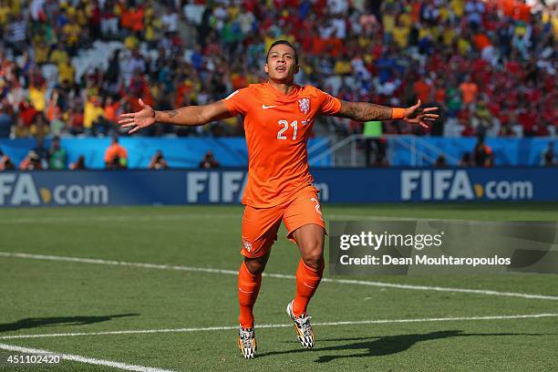 Memphis Depay of the Netherlands celebrates scoring his team's second goal during the 2014 FIFA World Cup Brazil Group B match between the...