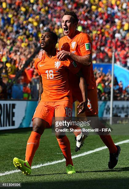Leroy Fer of the Netherlands celebrates scoring his team's first goal with his teammate Stefan de Vrij during the 2014 FIFA World Cup Brazil Group B...