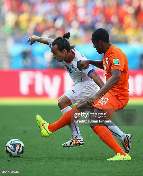 Jorge Valdivia of Chile and Leroy Fer of the Netherlands compete for the ball during the 2014 FIFA World Cup Brazil Group B match between the...