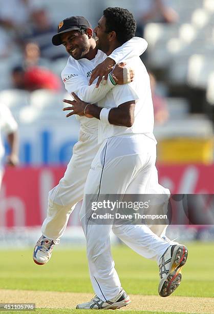 Dhammika Prasad of Sri Lanka is congratulated by Kaushal Silva of Sri Lanka after he bowled out Ian Bell of England during day four of the 2nd...