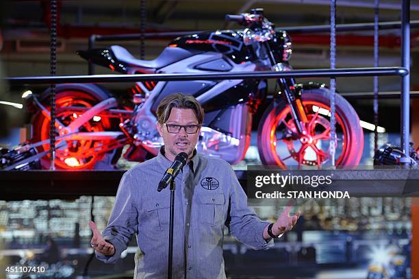 Harley-Davidson chief marketing officer Mark-Hans Richer, speaks in front of a Project LiveWire motorcycle, the company's first electric motorcycle,...