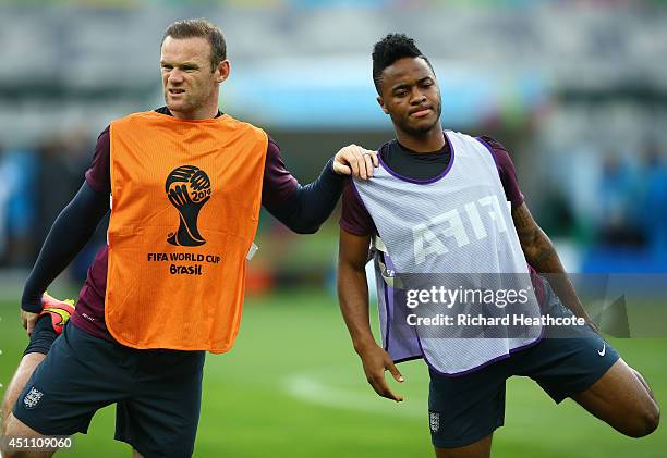 Wayne Rooney and Raheem Sterling of England stretch during an England training session ahead of the 2014 FIFA World Cup Brazil Group D match against...