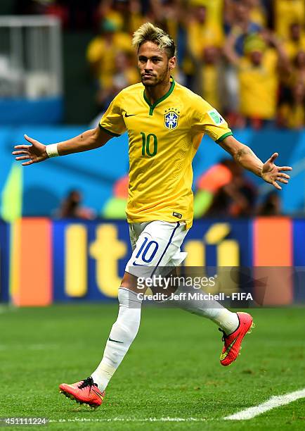 Neymar of Brazil celebrates scoring his team's first goal during the 2014 FIFA World Cup Brazil Group A match between Cameroon and Brazil at Estadio...