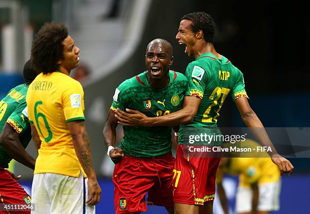 Joel Matip of Cameroon celebrates scoring his team's first goal with his teammate Allan Nyom during the 2014 FIFA World Cup Brazil Group A match...