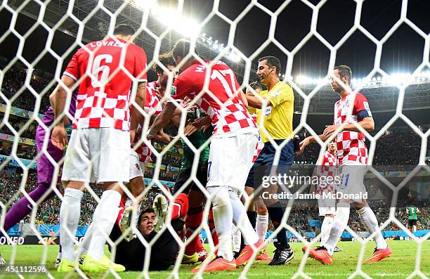 Croatia players react as goalkeeper Stipe Pletikosa of Croatia lies on the pitch after being fouled during the 2014 FIFA World Cup Brazil Group A...