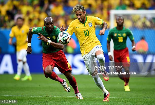 Neymar of Brazil and Stephane Mbia of Cameroon compete for the ball during the 2014 FIFA World Cup Brazil Group A match between Cameroon and Brazil...