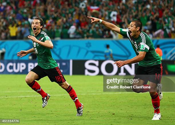 Andres Guardado and Javier Hernandez of Mexico celebrate their team's second goal during the 2014 FIFA World Cup Brazil Group A match between Croatia...