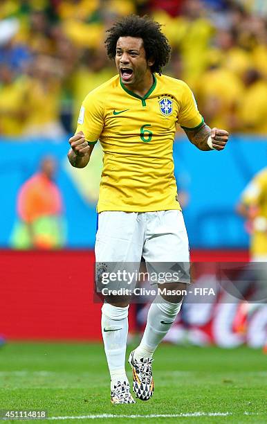 Marcelo of Brazil celebrates his team's first goal by Neymar during the 2014 FIFA World Cup Brazil Group A match between Cameroon and Brazil at...