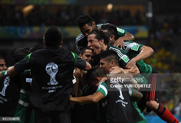 Mexico's players celebrate after scoring the 0-1 during a Group A football match between Croatia and Mexico at the Pernambuco Arena in Recife during...