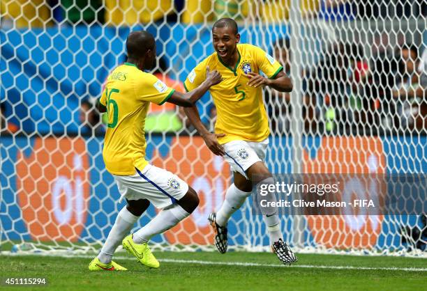 Fernandinho of Brazil celebrates scoring his team's fourth goal with his teammate Ramires during the 2014 FIFA World Cup Brazil Group A match between...