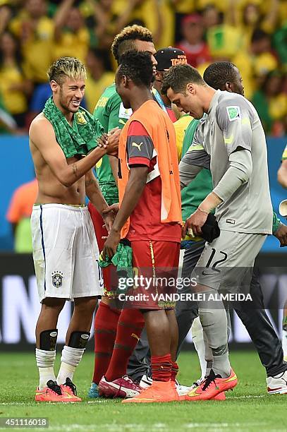 Brazil's forward Neymar shakes hands with Cameroon's forward Fabrice Olinga at the end of their Group A football match between Cameroon and Brazil at...
