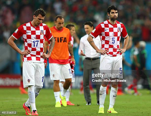 Mario Mandzukic and Vedran Corluka of Croatia look dejected after a 3-1 defeat in the 2014 FIFA World Cup Brazil Group A match between Croatia and...