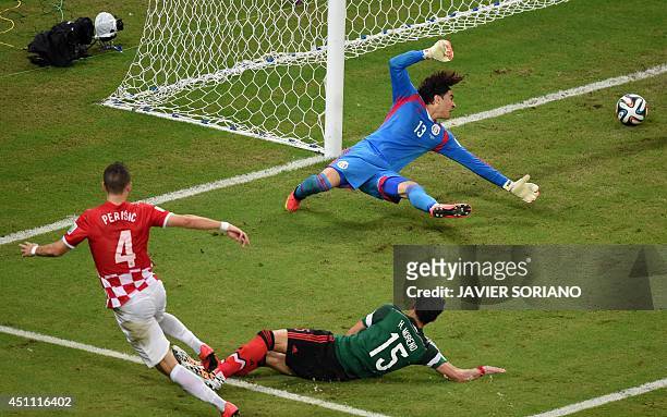 Mexico's goalkeeper Guillermo Ochoa fails to save Croatia's first goal, scored by Croatia's midfielder Ivan Perisic during a Group A football match...