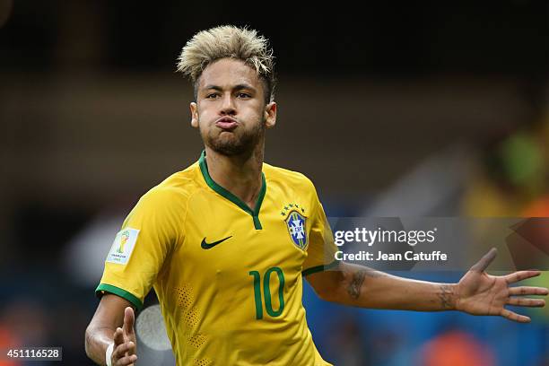 Neymar of Brazil celebrates scoring his team's second goal during the 2014 FIFA World Cup Brazil Group A match between Cameroon and Brazil at Estadio...