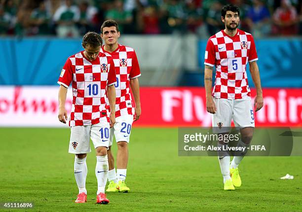 Luka Modric, Mateo Kovacic and Vedran Corluka of Croatia walk off the pitch after the 1-3 defeat in the 2014 FIFA World Cup Brazil Group A match...