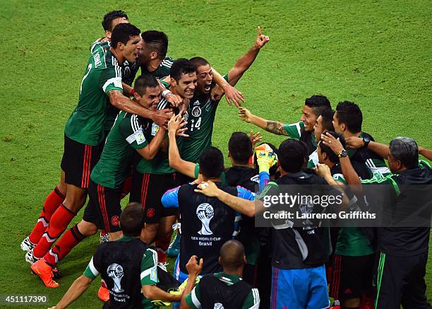 Rafael Marquez of Mexico celebrates with teammates scoring his team's first goal during the 2014 FIFA World Cup Brazil Group A match between Croatia...