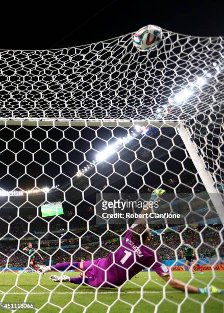 Andres Guardado of Mexico scores his team's second goal past goalkeeper Stipe Pletikosa of Croatia during the 2014 FIFA World Cup Brazil Group A...