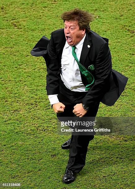 Head coach Miguel Herrera of Mexico celebrates after his team's first goal during the 2014 FIFA World Cup Brazil Group A match between Croatia and...