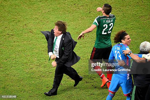 Head coach Miguel Herrera of Mexico celebrates after his team's first goal during the 2014 FIFA World Cup Brazil Group A match between Croatia and...