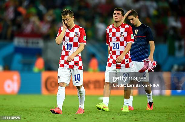 Luka Modric of Croatia walks off the pitch dejected with team-mates after losing the 2014 FIFA World Cup Brazil Group A match between Croatia and...