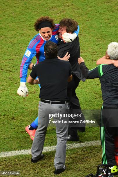 Guillermo Ochoa of Mexico celebrates with head coach Miguel Herrera during the 2014 FIFA World Cup Brazil Group A match between Croatia and Mexico at...