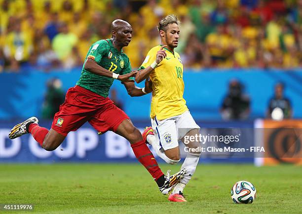 Stephane Mbia of Cameroon challenges Neymar of Brazil during the 2014 FIFA World Cup Brazil Group A match between Cameroon and Brazil at Estadio...