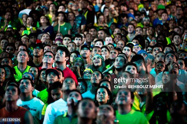 Brazil supporters watch a Group A FIFA World Cup match between Brazil and Cameroon at the Fan Fest in Salvador, Brazil on June 23, 2014. AFP PHOTO /...