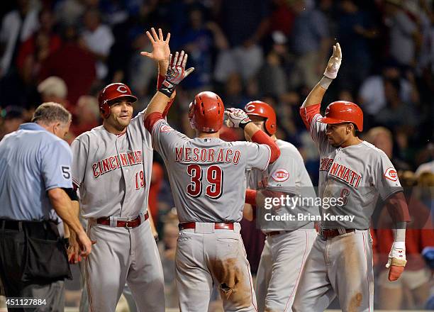 Joey Votto , Todd Frazier and Billy Hamilton of the Cincinnati Reds congratulate teammate Devin Mesoraco at home plate after Mesoraco hit a grand...