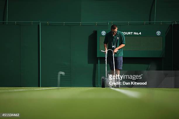 The grass courts are prepared prior to the matches on day two of the Wimbledon Lawn Tennis Championships at the All England Lawn Tennis and Croquet...
