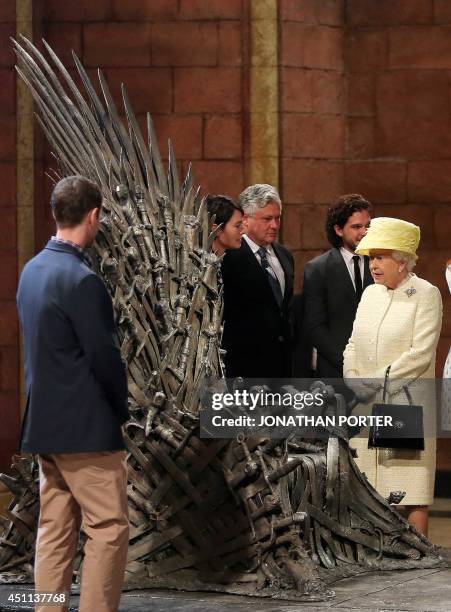 Britain's Queen Elizabeth II views the giant "Iron Throne" prop during her visit to the set of the HBO TV series "Game of Thrones" in the Titanic...