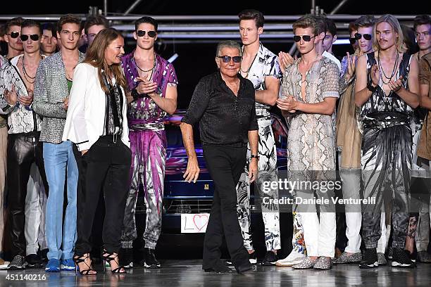 Designer Eva Cavalli and Roberto Cavalli acknowledge the applause of the audience after the Roberto Cavalli show as part of Milan Fashion Week...