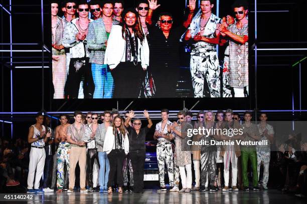Designer Eva Cavalli and Roberto Cavalli acknowledge the applause of the audience after the Roberto Cavalli show as part of Milan Fashion Week...