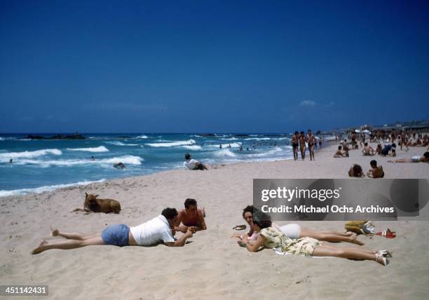 View of young couples resting on a beach in Beirut, Lebanon.