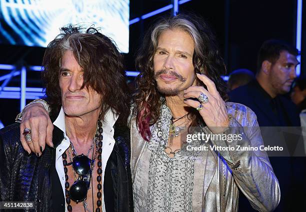 Joe Perry and Steven Tyler attend the Roberto Cavalli show during the Milan Menswear Fashion Week Spring Summer 2015 on June 24, 2014 in Milan, Italy.