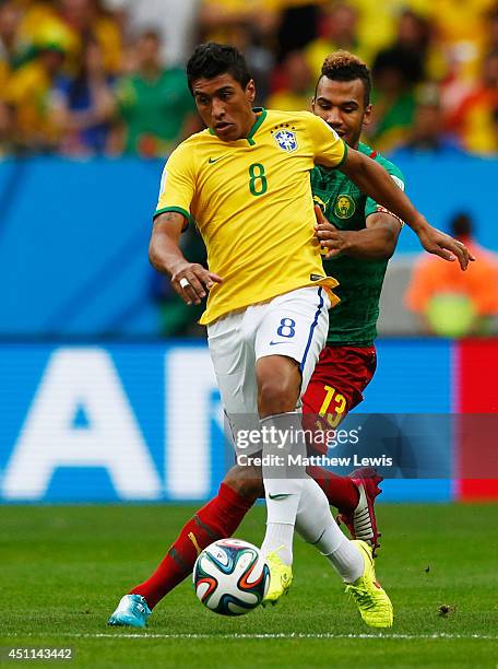 Paulinho of Brazil holds off Maxim Choupo-Moting of Cameroon during the 2014 FIFA World Cup Brazil Group A match between Cameroon and Brazil at...