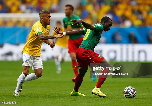 Vincent Aboubakar of Cameroon evades Dani Alves of Brazil during the 2014 FIFA World Cup Brazil Group A match between Cameroon and Brazil at Estadio...