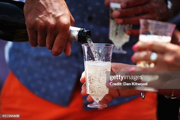 Tennis spectators drinking champagne on day two of the Wimbledon Lawn Tennis Championships at the All England Lawn Tennis and Croquet Club at...