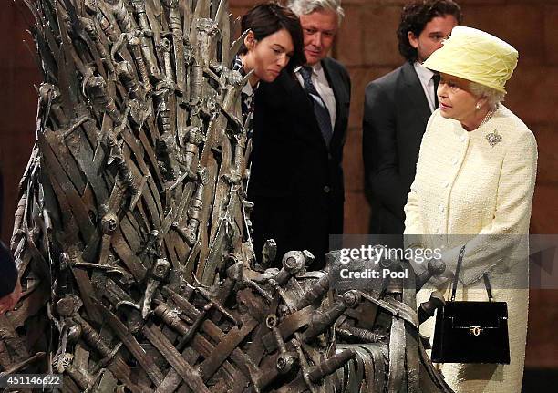 Queen Elizabeth II meets cast members of the HBO TV series 'Game of Thrones' Lena Headey and Conleth Hill as she views some of the props including...