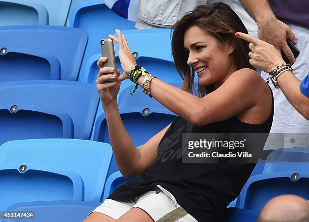 Alena Seredova, wife of Gianluigi Buffon of Italy, take a photograph ahead of the 2014 FIFA World Cup Brazil Group D match between Italy and Uruguay...