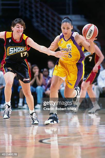 Allison Feaster of the Los Angeles Sparks drives against Elena Tornikidou of the Detroit Shock at Staples Center on May 29, 1999 in Los Angeles, CA....