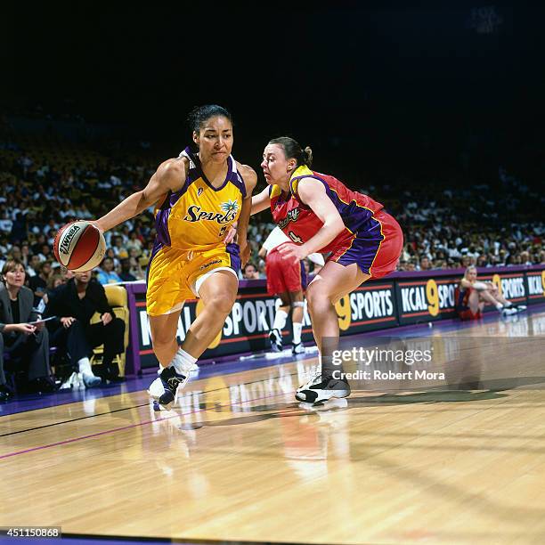 Allison Feaster of the Los Angeles Sparks drives against the Phoenix Mercury at Staples Center on July 11, 1999 in Los Angeles, CA. NOTE TO USER:...